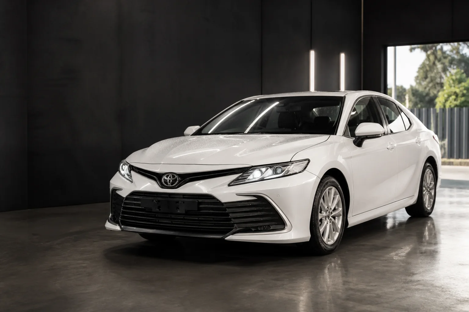 Clean white Toyota Camry family sedan with a polished finish